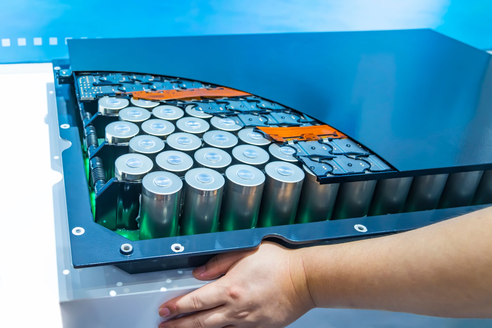 hand with Lithium ion industrial high current batteries and connector