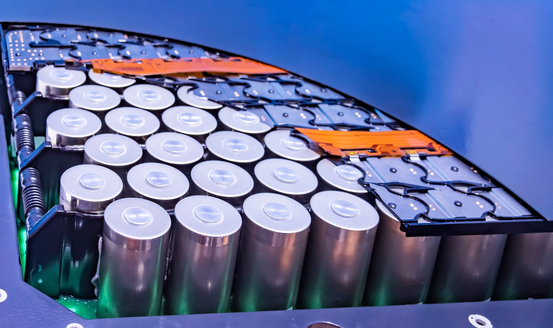 Metal parts with shiny steel cylindrical surface closeup. disassembled lithium ion form factor cell battery pack.